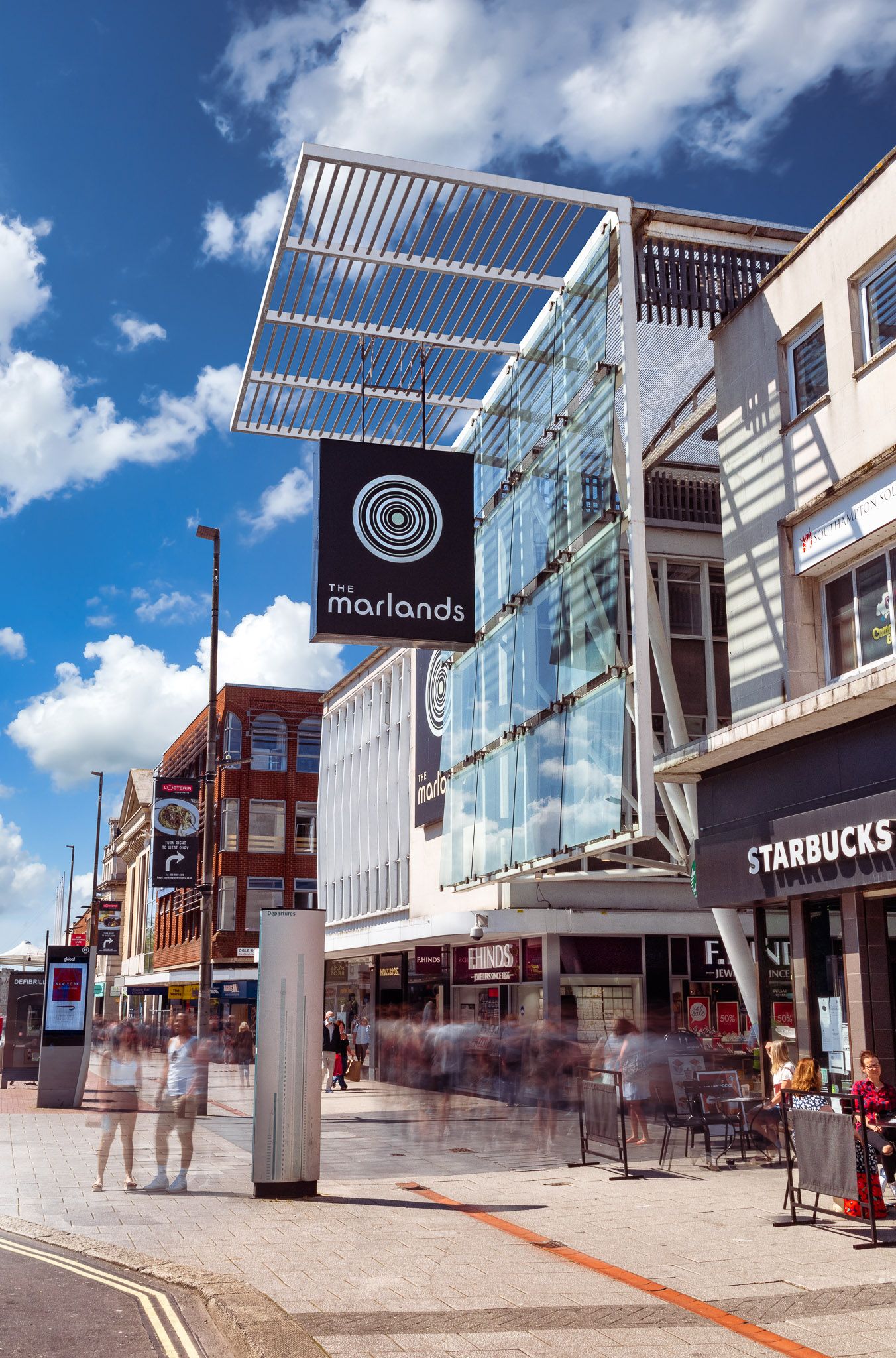 The Marlands shopping centre Southampton with modern glass and steel canopy, Starbucks and pedestrians, architectural exterior photography