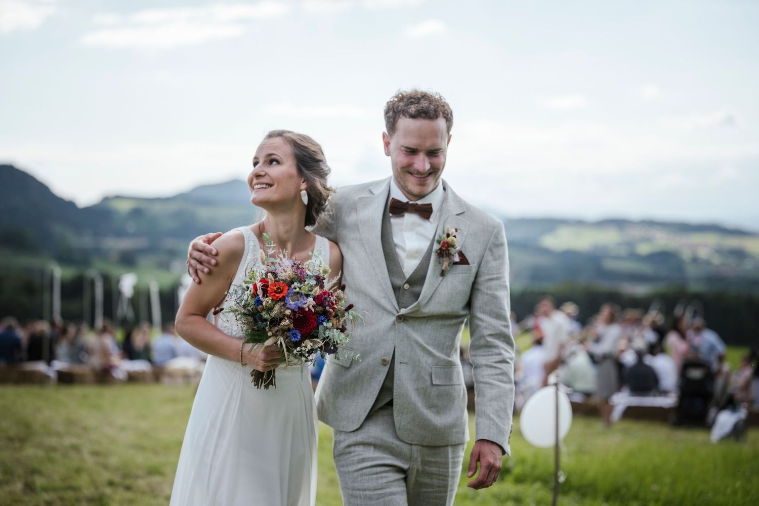 Outdoor wedding photography sequence showing joyful moments in a scenic mountain setting.