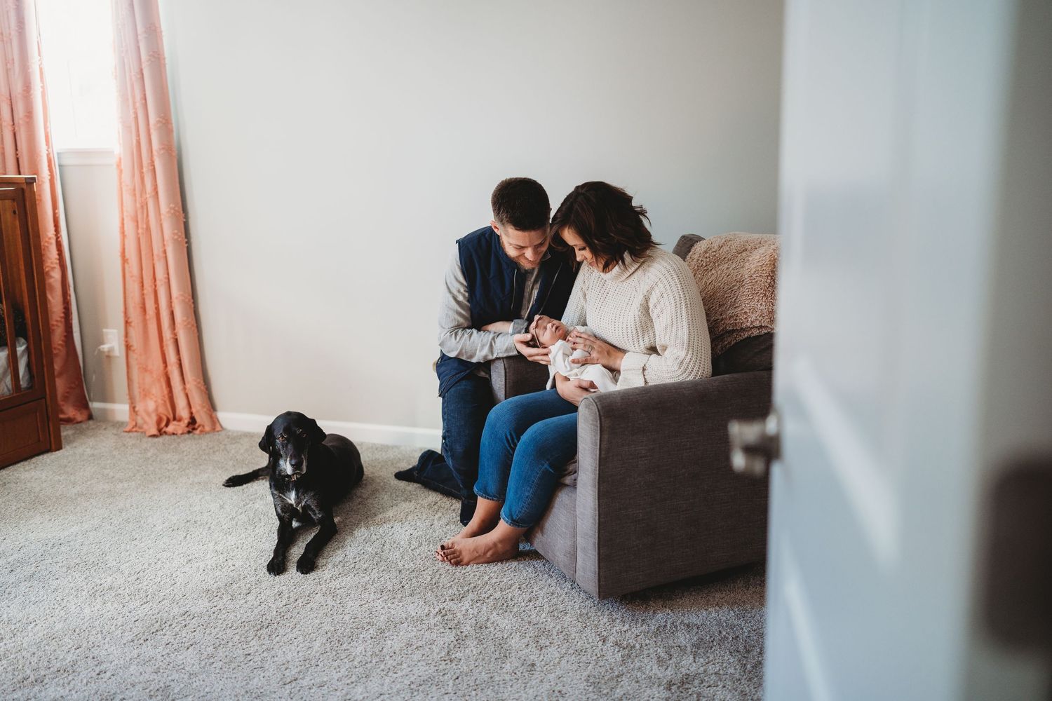 Candid family moments captured in a bright minimalist room with cozy seating.