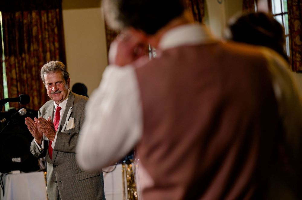 Guests enjoying emotional moments during wedding speeches at a reception.