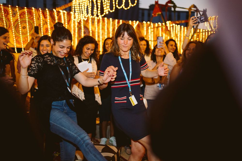 Event attendees engaging at a festively lit networking function.