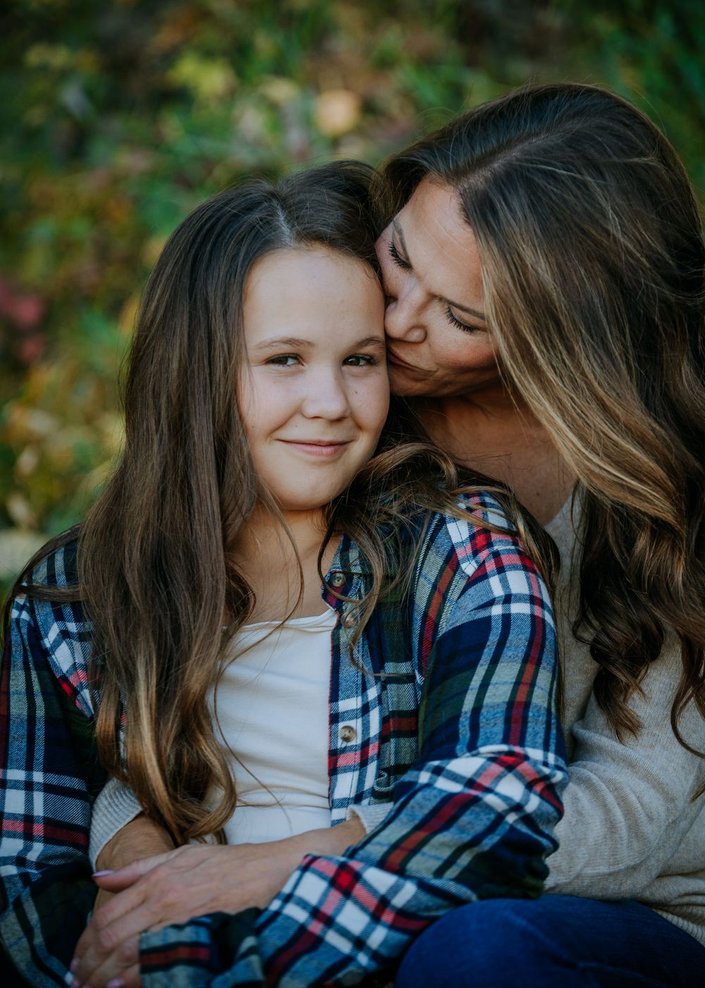 An intimate portrait of affection captured in warm autumn lighting.