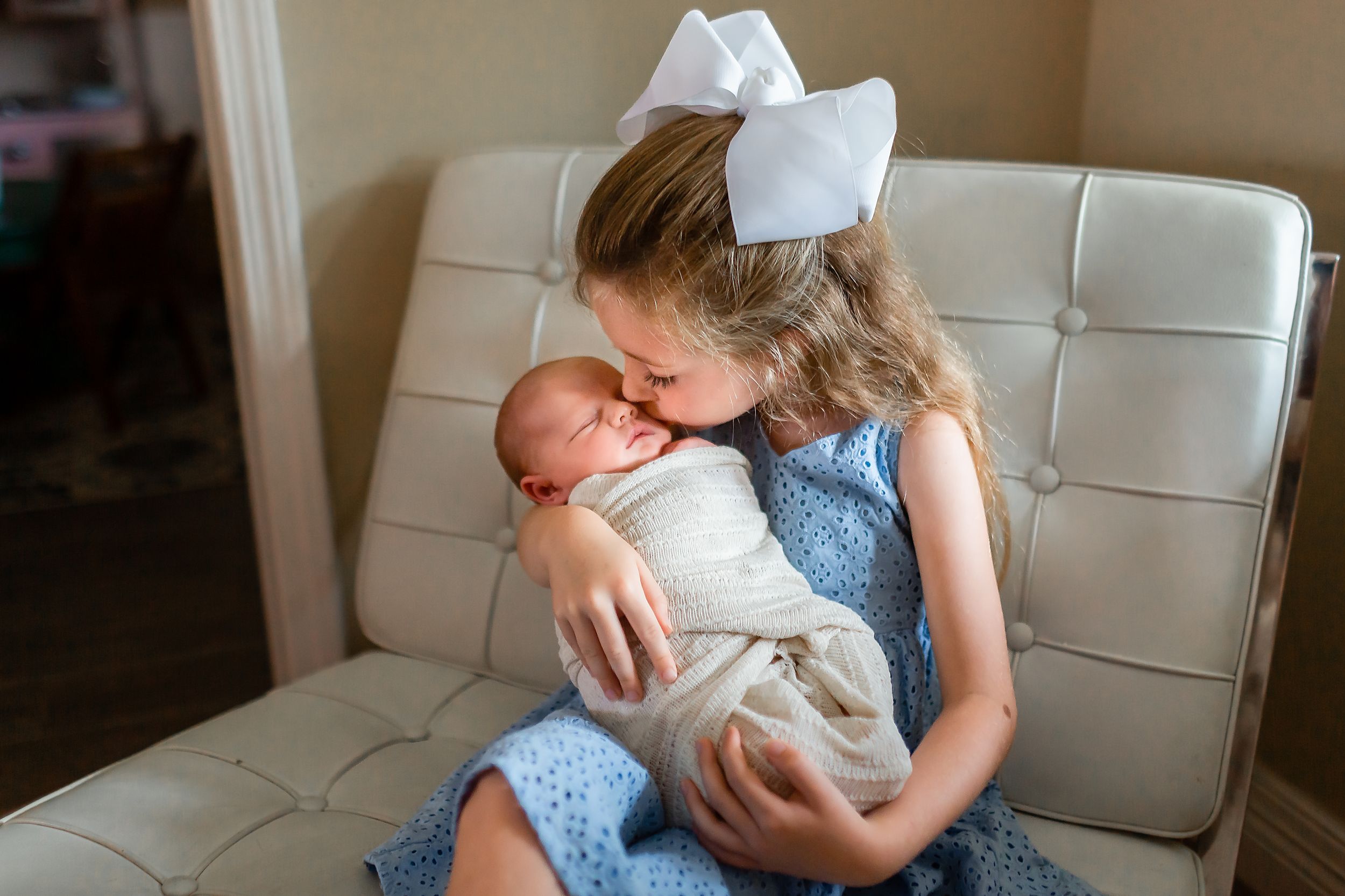Big sister kisses new baby sister in Houston, TX.