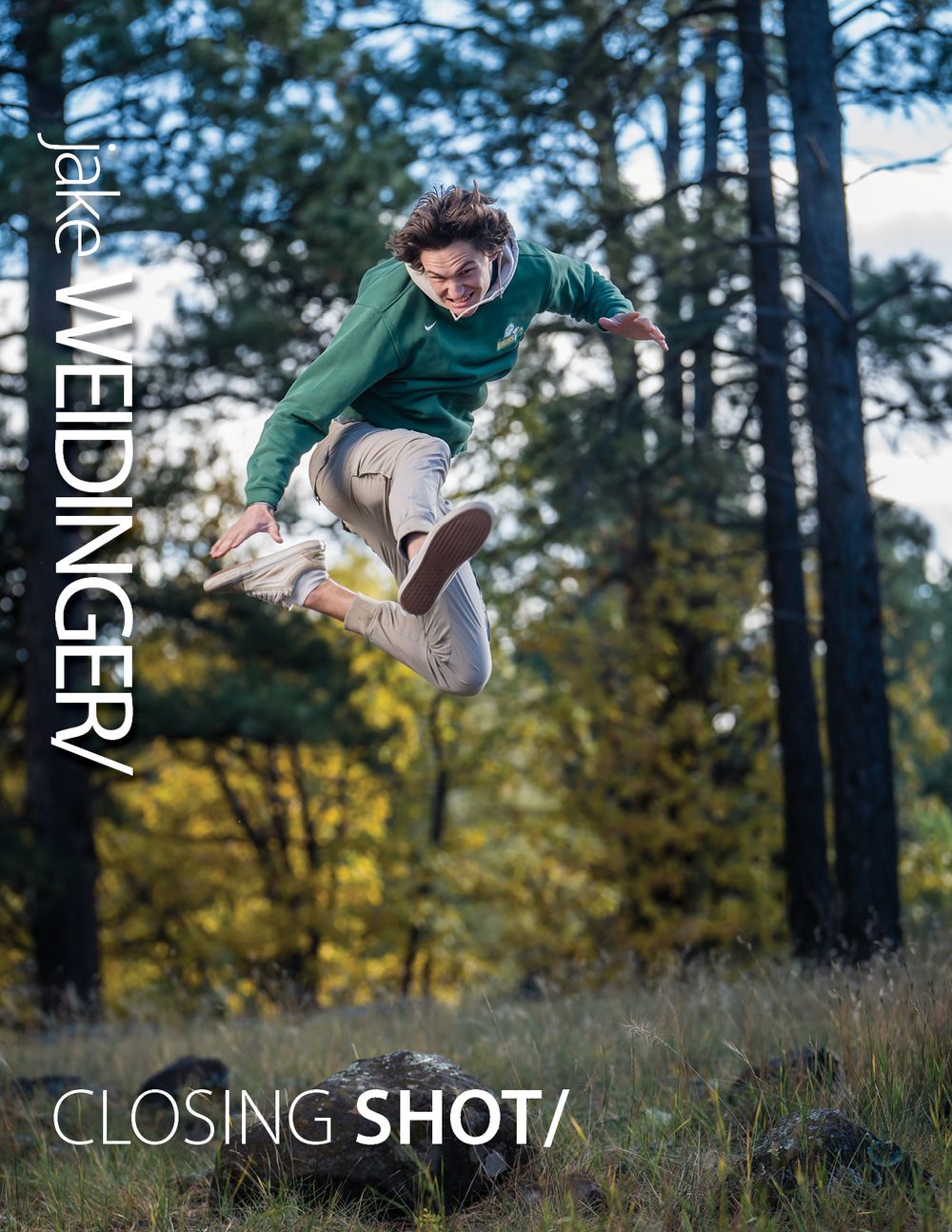 Person in green hoodie jumping high in outdoor forest setting for action shot.