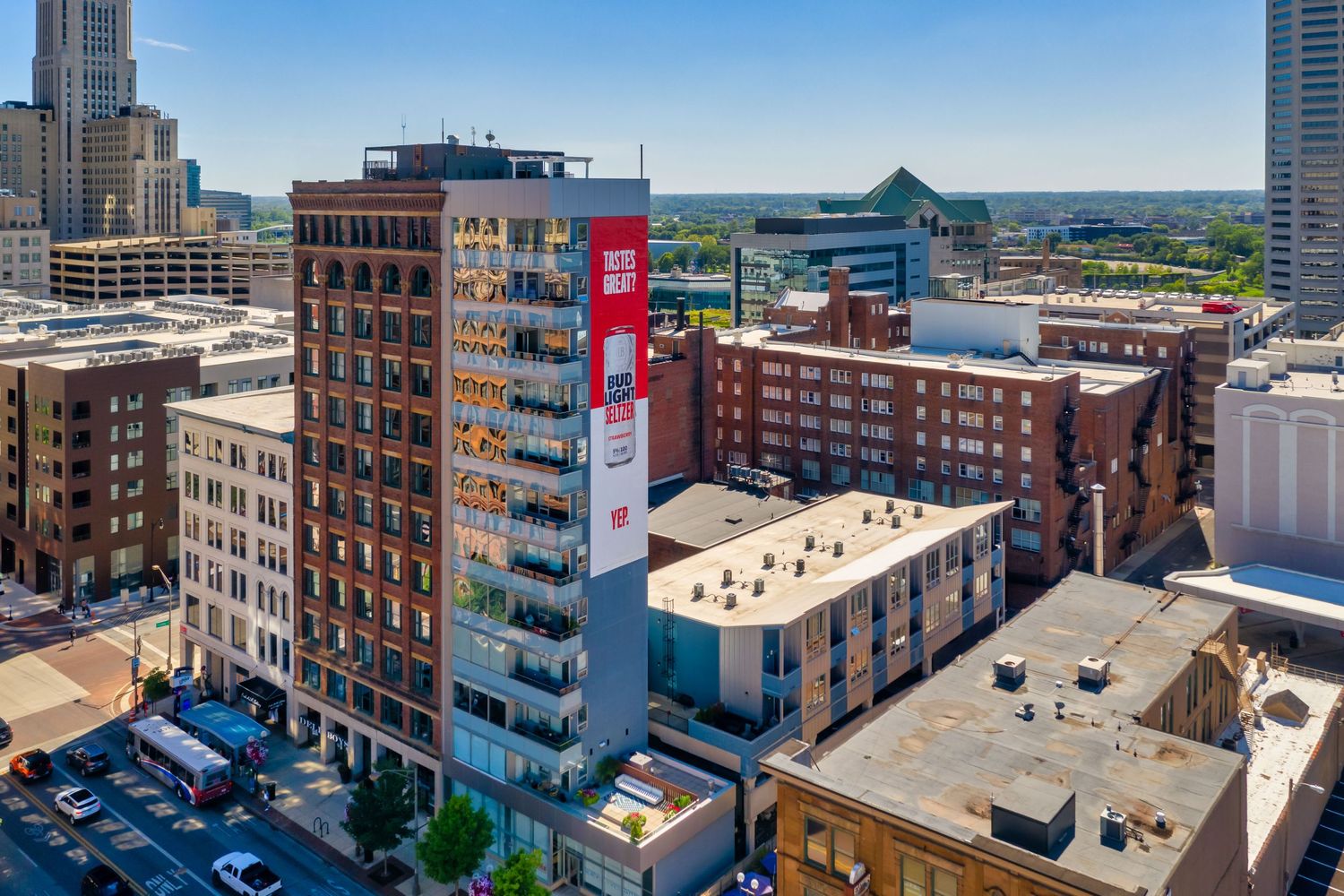 Aerial view of downtown Columbus Ohio buildings and architecture with red vertical sign on modern high-rise structure.