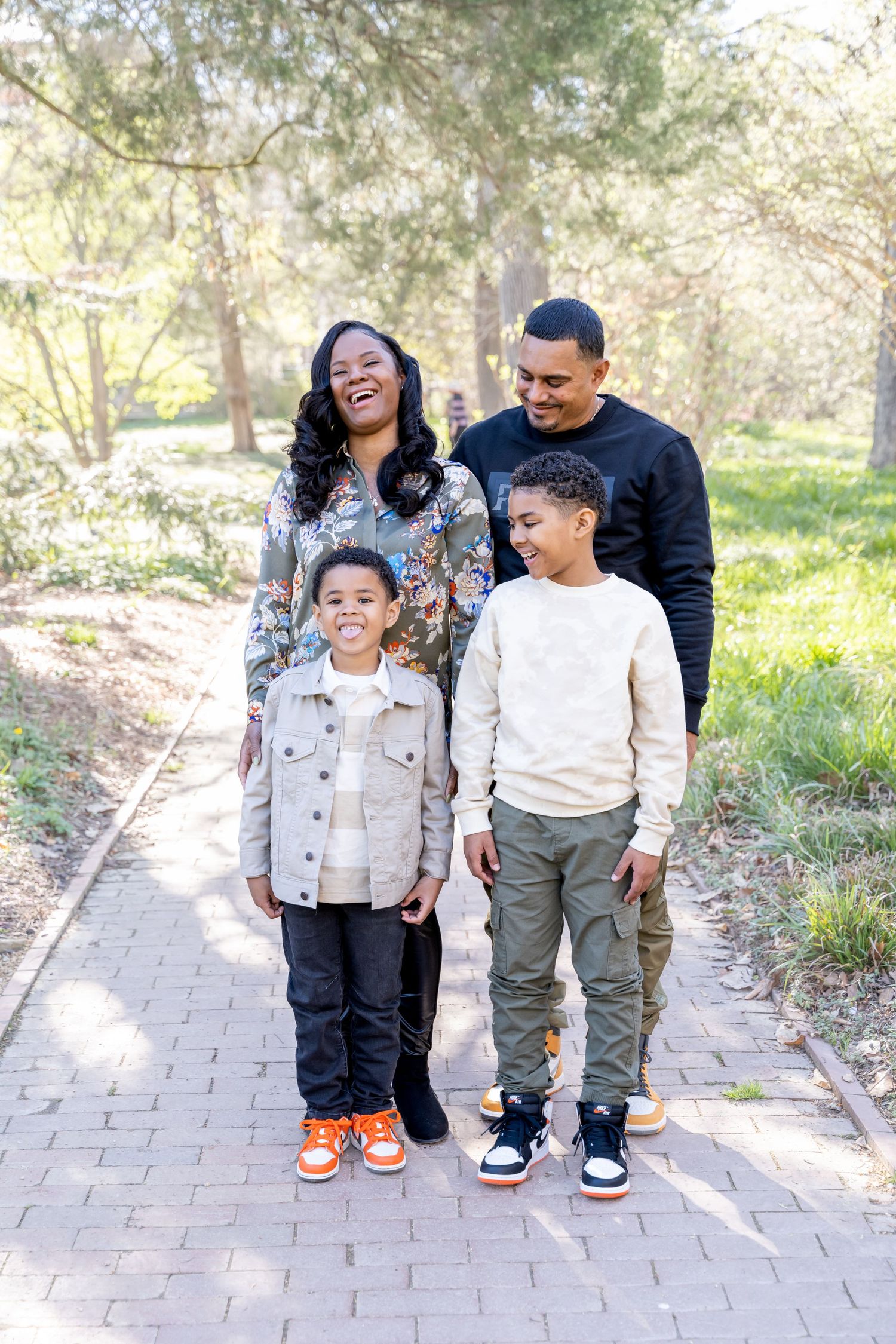 Family laughing while their son sticks out his tongue