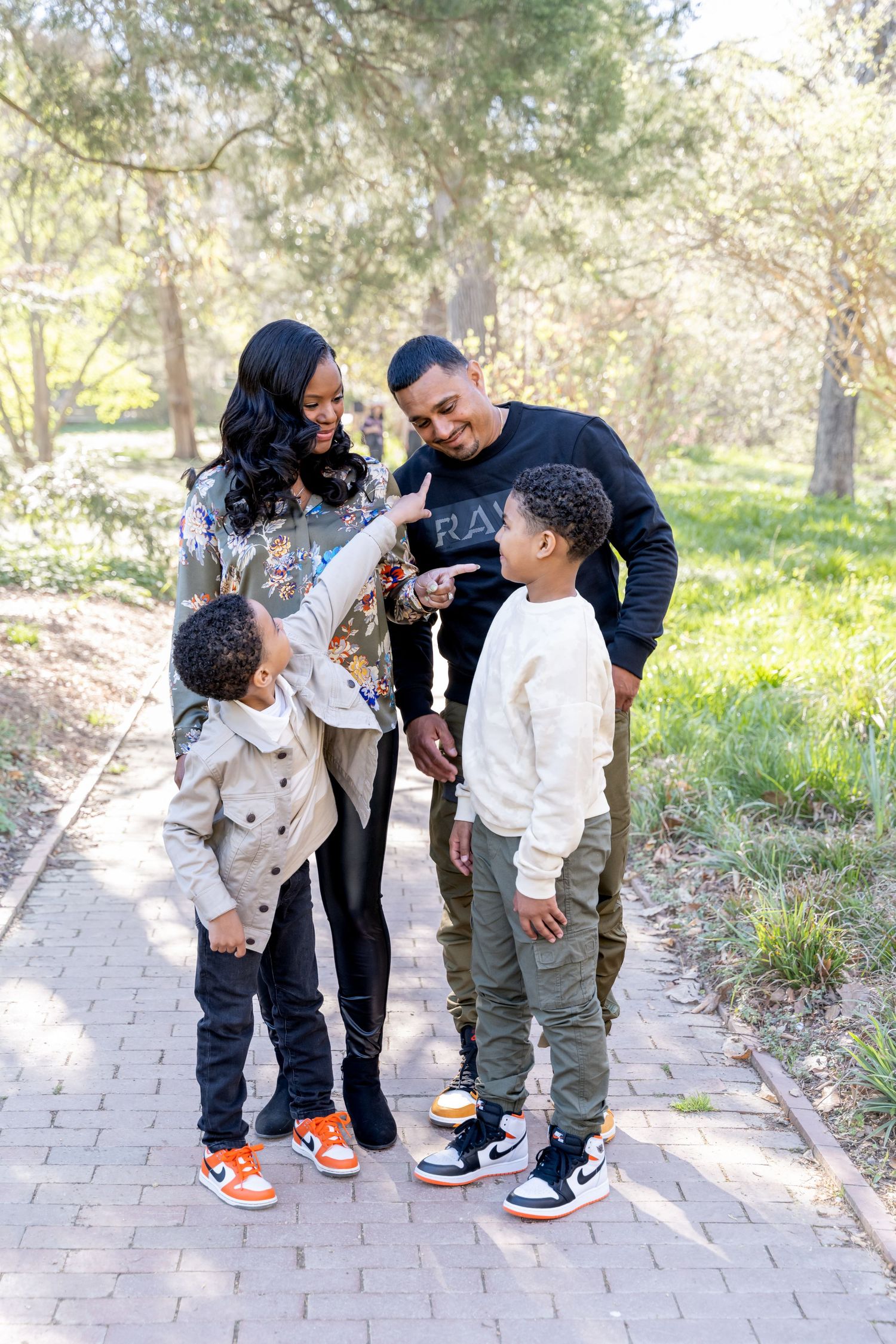 Family pointing at each other laughing during family portraits