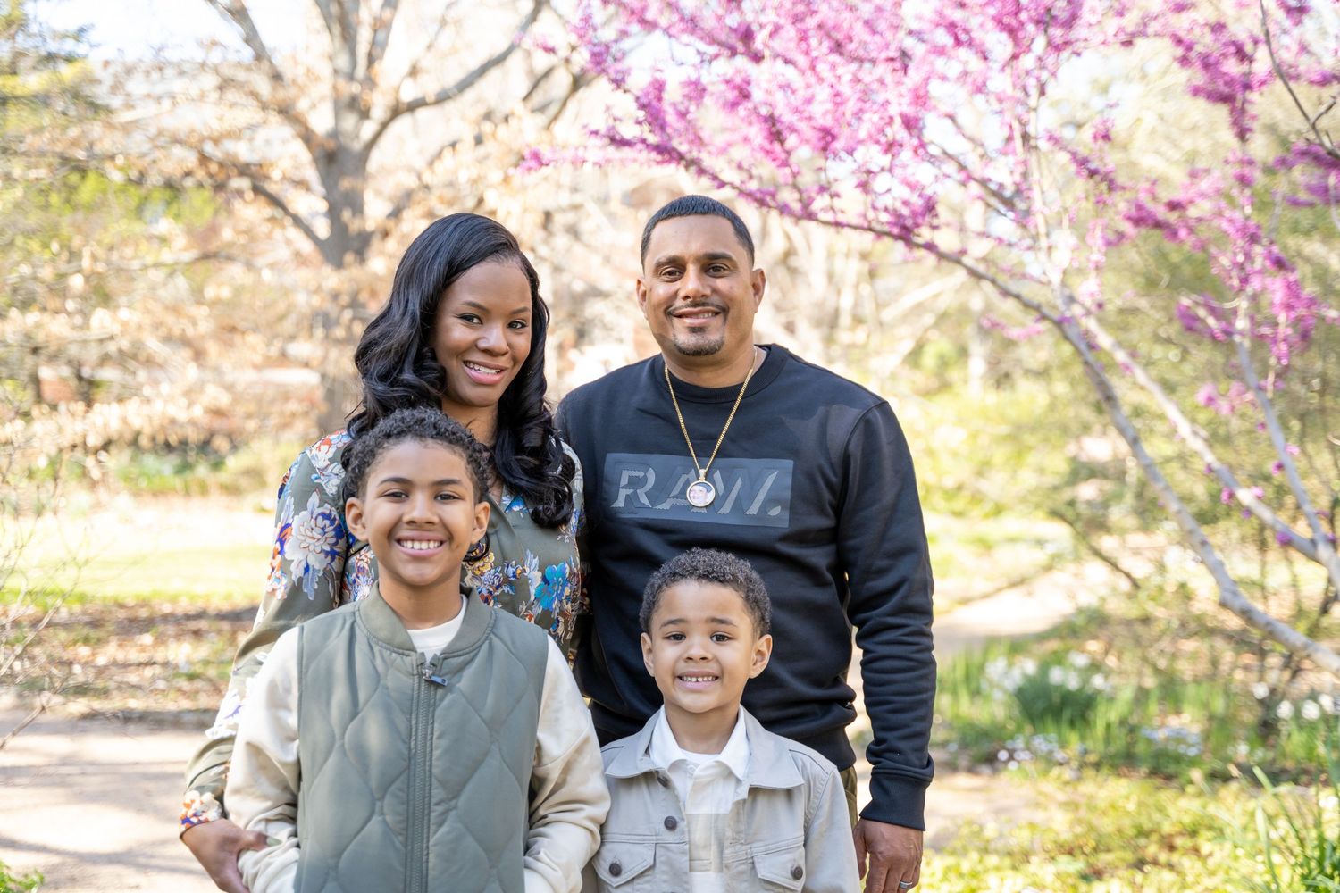 Family portrait under blossom tree at family portraits at Coker Arboretum in Chapel Hill, NC