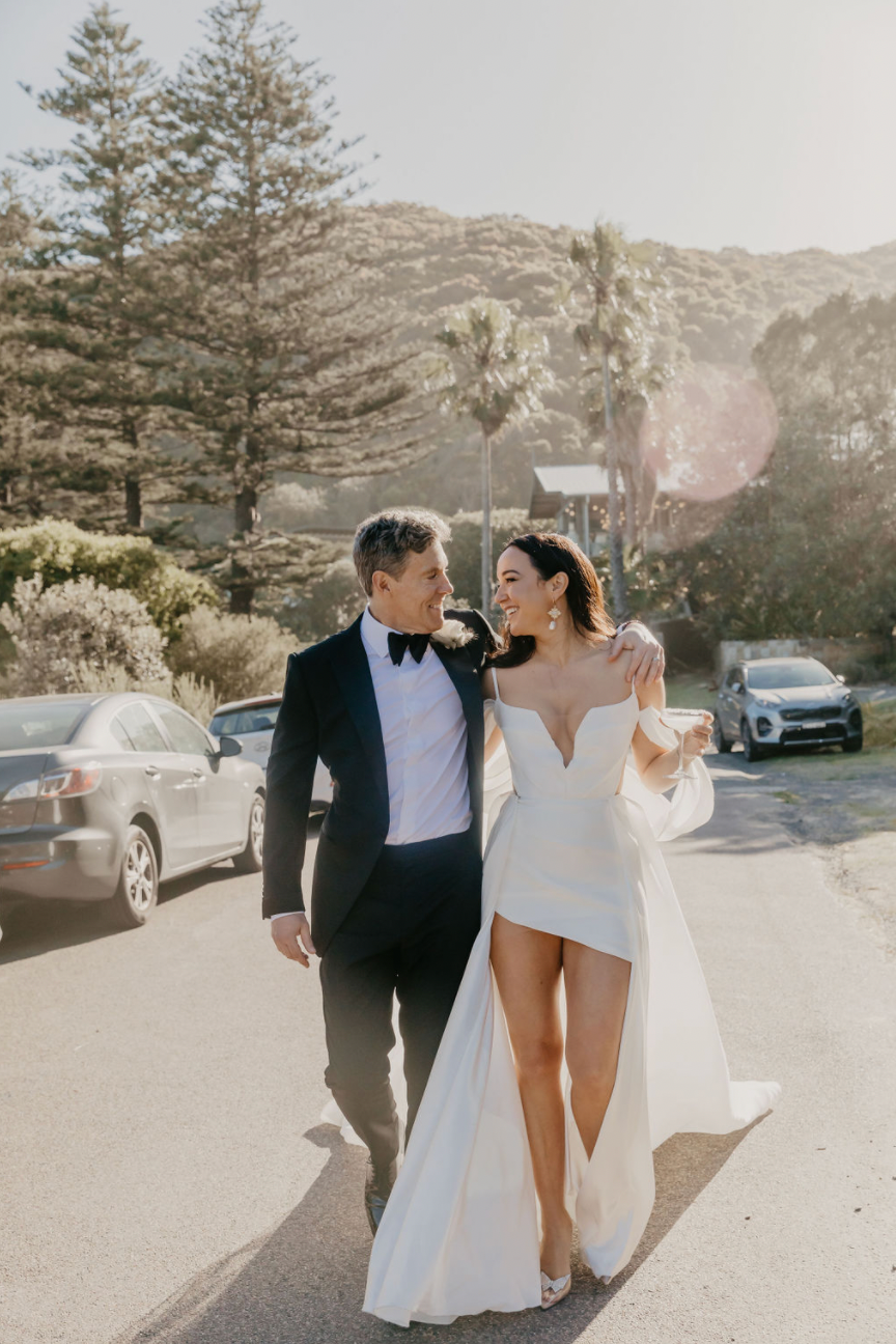 Newlyweds walking together after their Byron Bay wedding ceremony, celebrating their first moments as husband and wife.