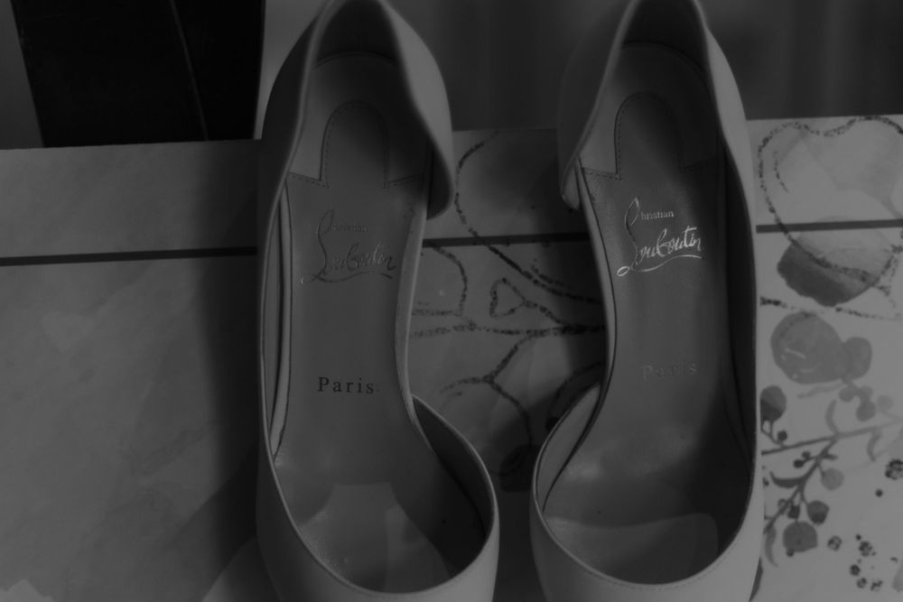 A pair of classic black wedding heels photographed in black and white.