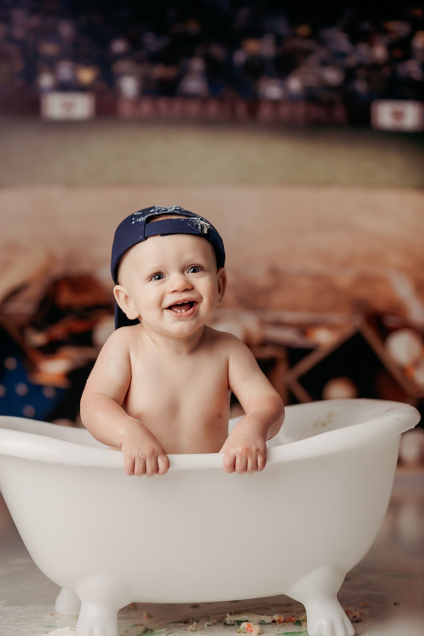 baby-boy-in-his-splash-bath-after-his-baseball-theme-cake-smash