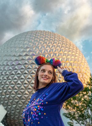 Disney's EPCOT Spaceship Earth geodesic sphere against cloudy sunset sky.