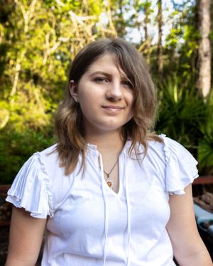 Garden portrait in soft natural lighting with lush greenery background.