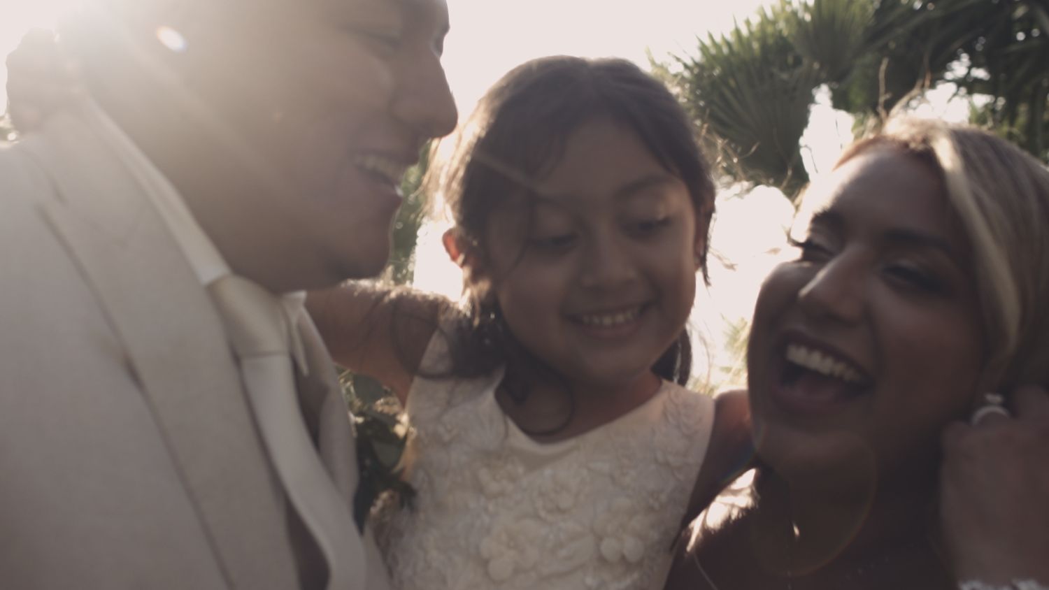 Joyful wedding moment captured in natural sunlight with candid laughter.
