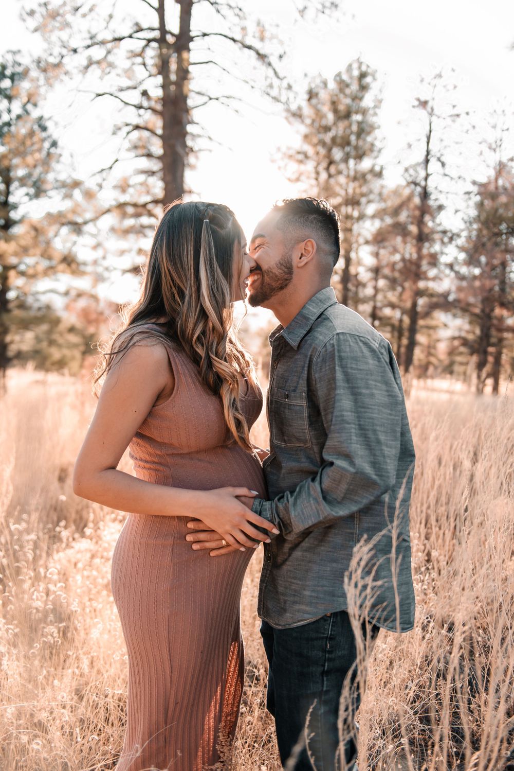 Sweet maternity session moments captured in natural outdoor setting.