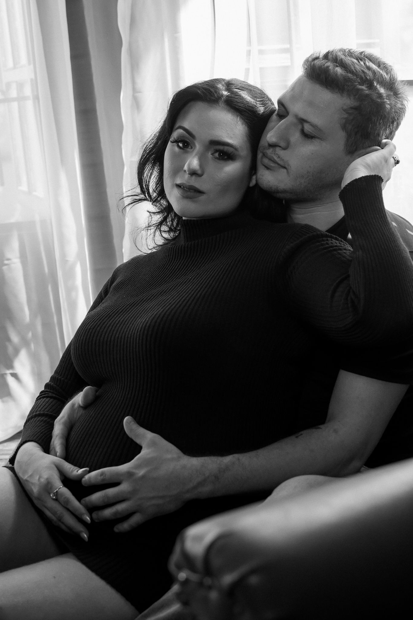 Black and white intimate couple's portrait showing tender embrace.