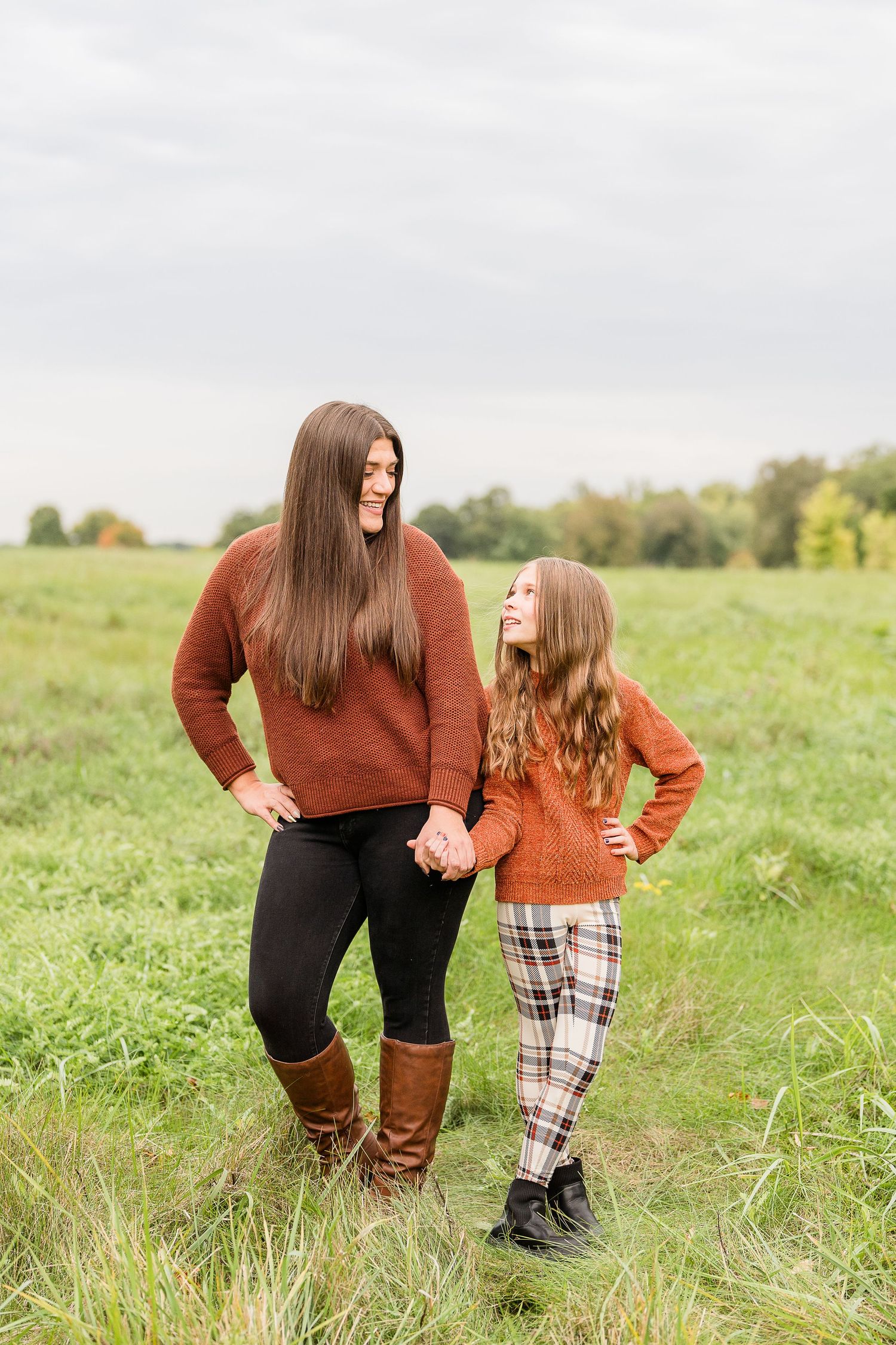 aunt and niece photoshoot at busse woods. standing in a field posing taken by a milwaukee wedding photographer