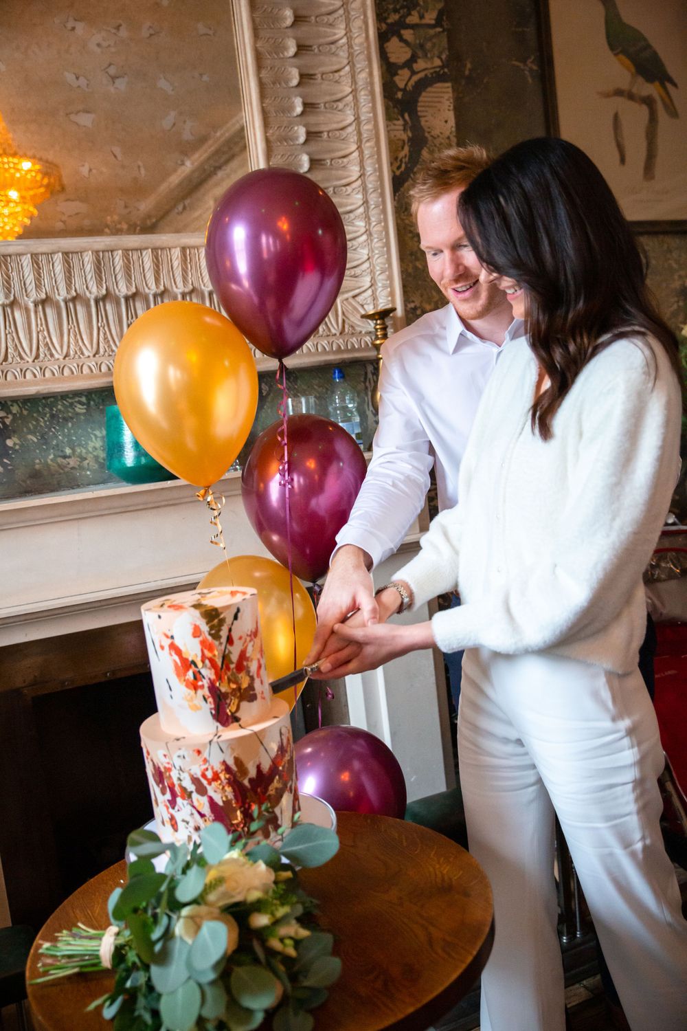 bride and groom cutting wedding cake