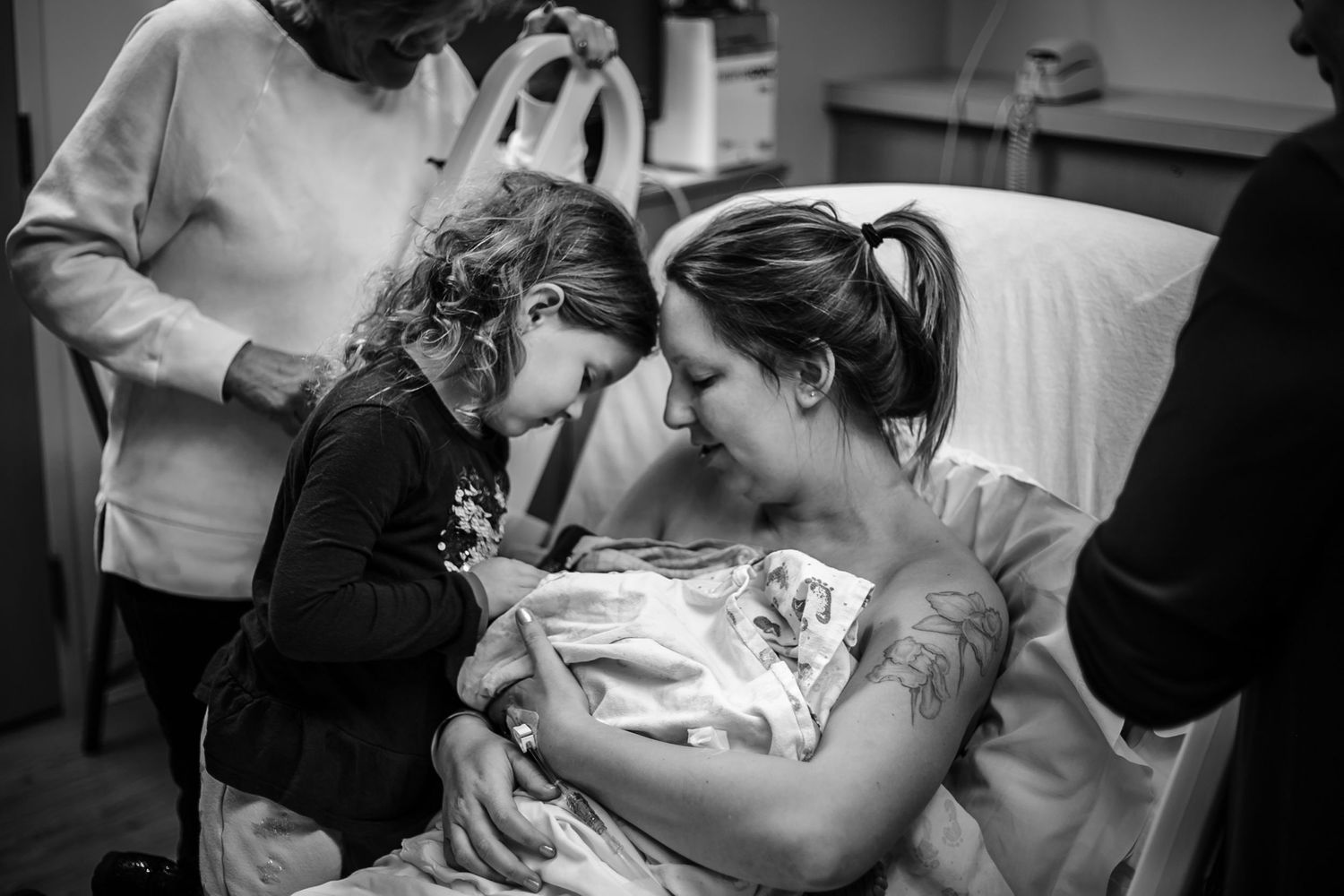 Mother introducing her daughter to her newborn brother just after birth at UnityPoint Health in Sioux City, Ia.