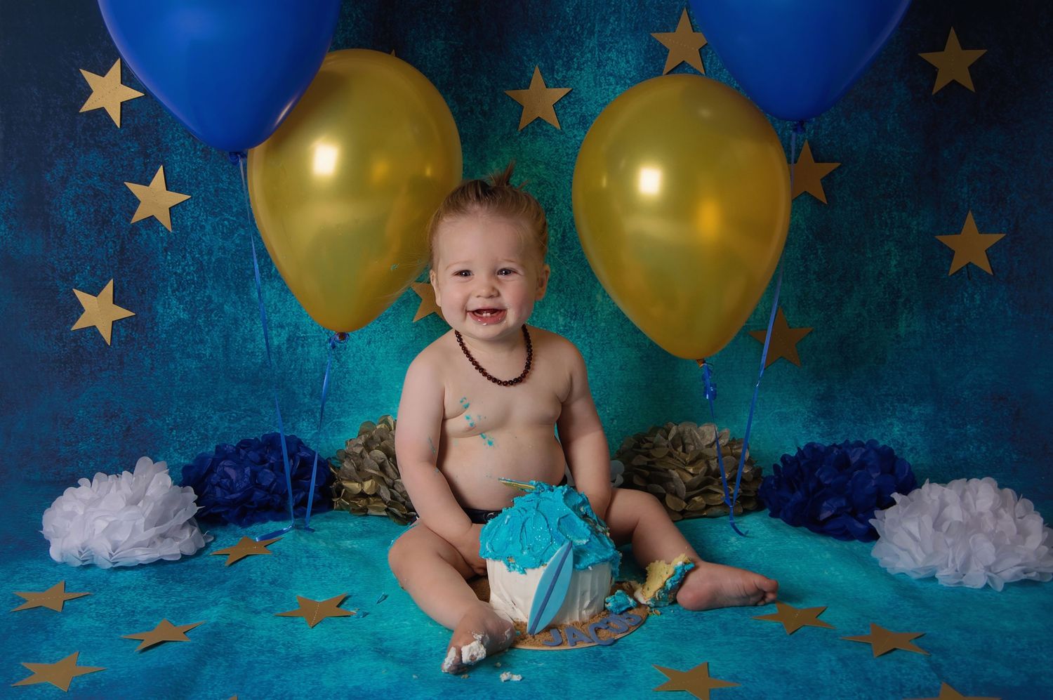 baby smiling with cake