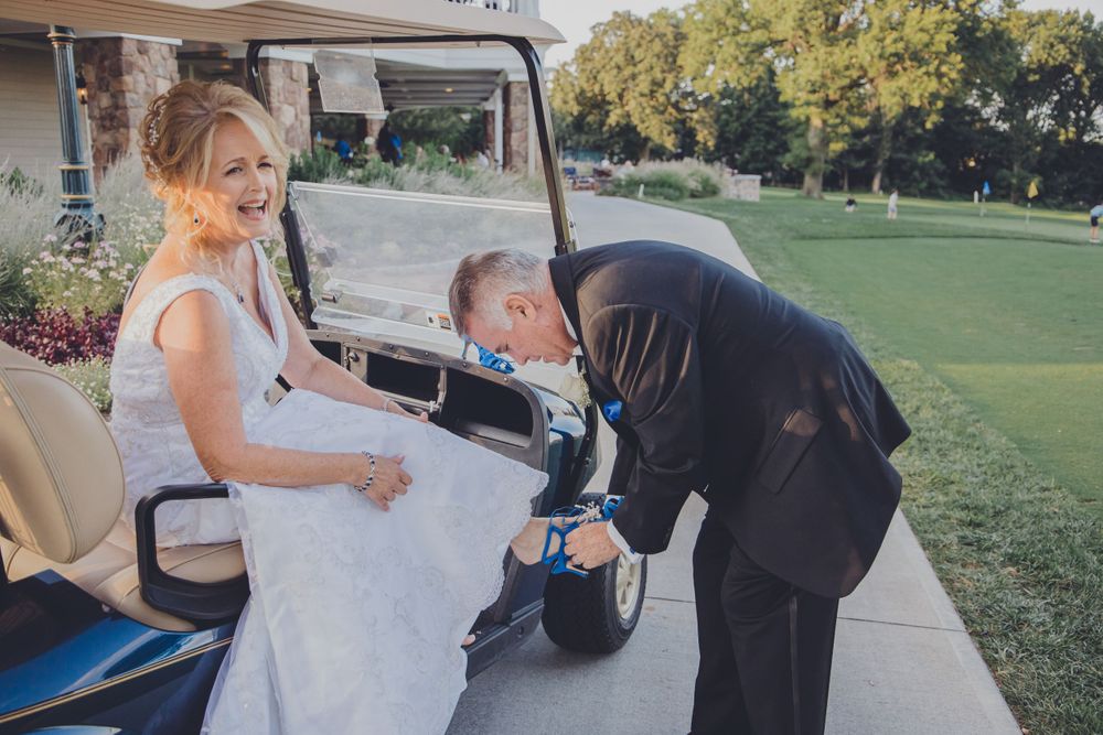 Wedding couple takes fun golf-themed photos on a course.