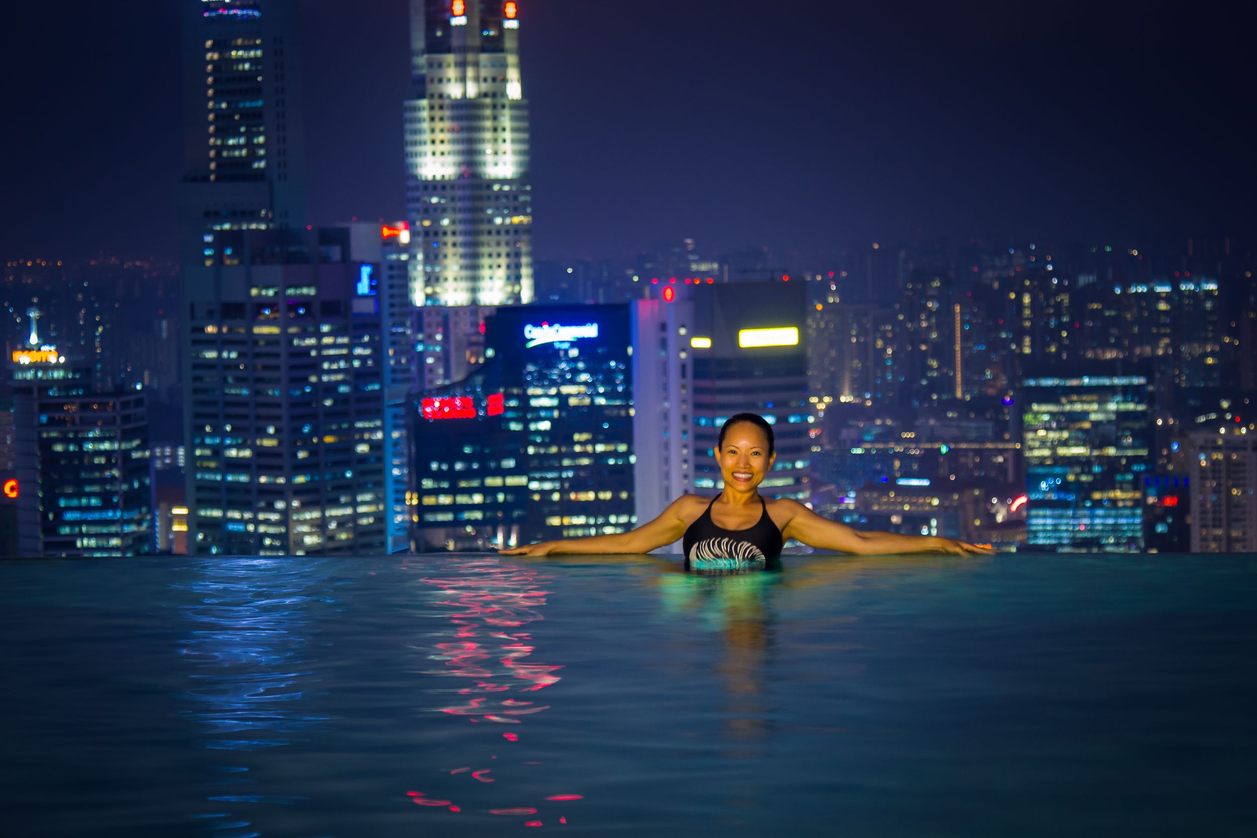 Portrait of asian girl in infinite pool on Marina Bay Sands Singapore.