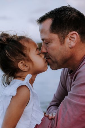 Close-up shots of tender family interactions against a blurred background.