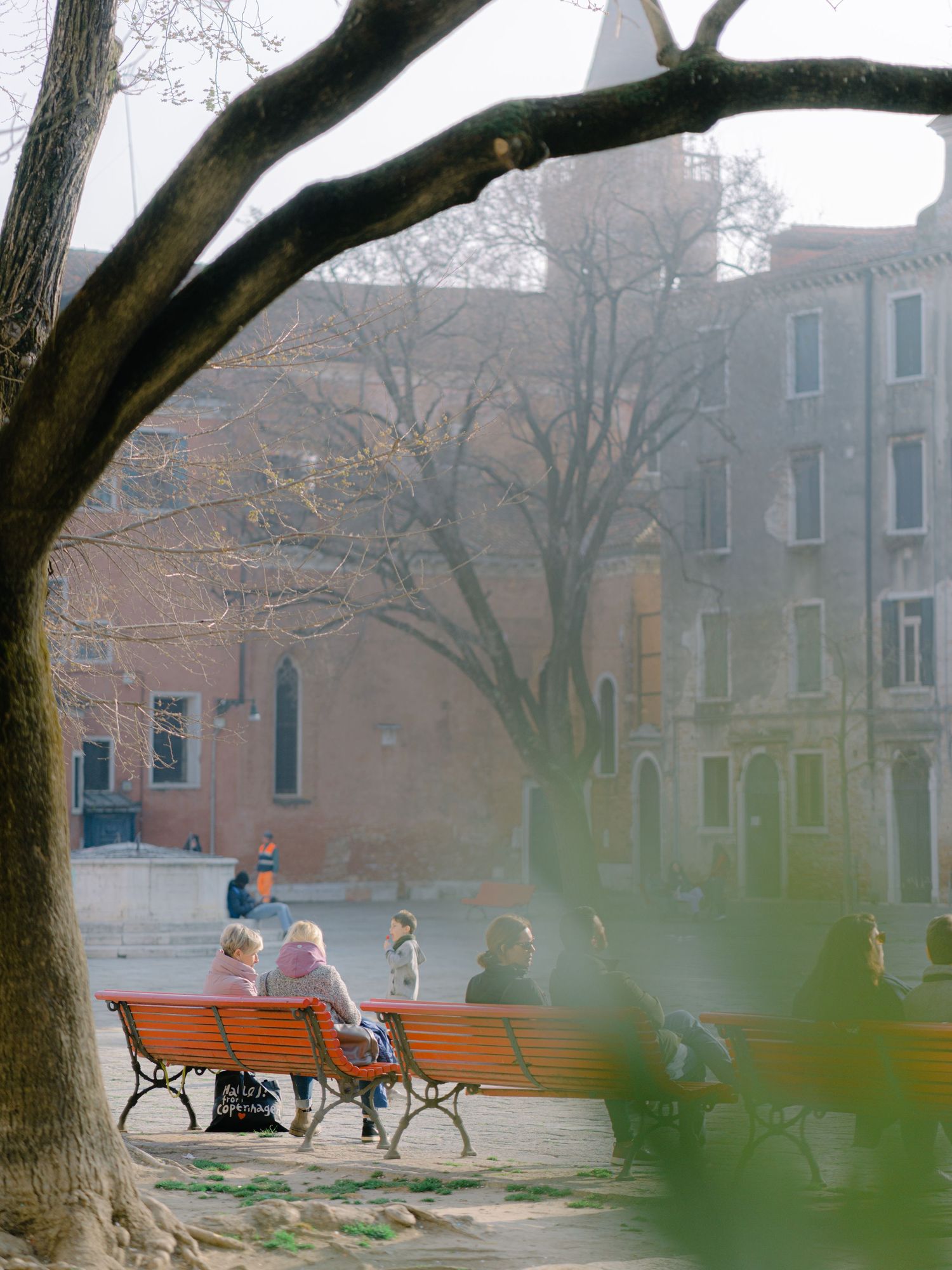 People relaxing in a park in Venice Italy