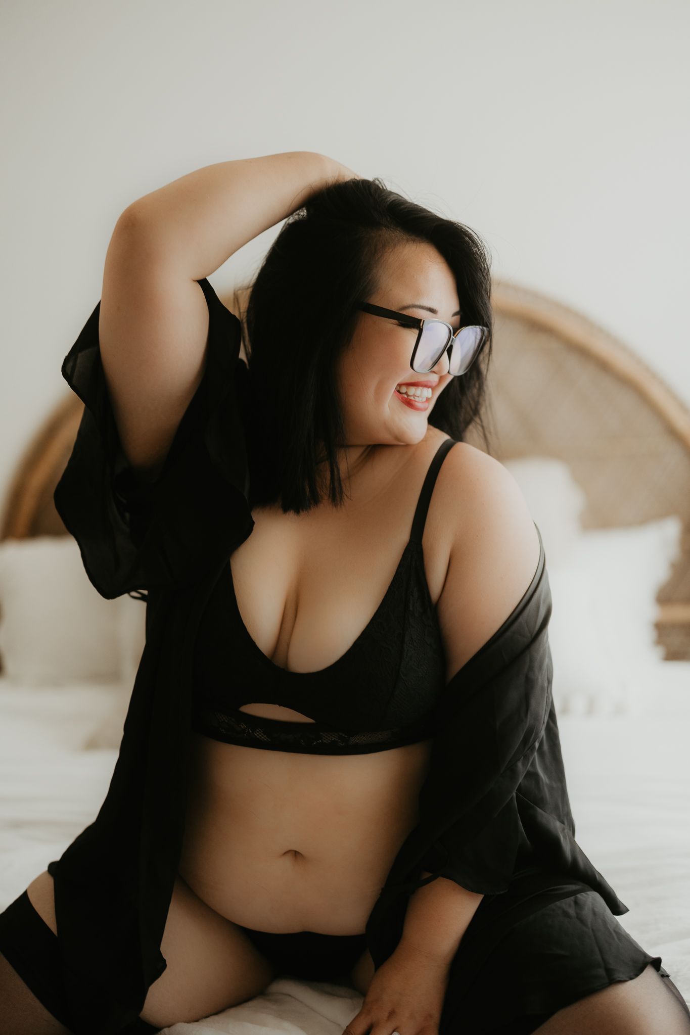 Artistic boudoir photography with natural window lighting.