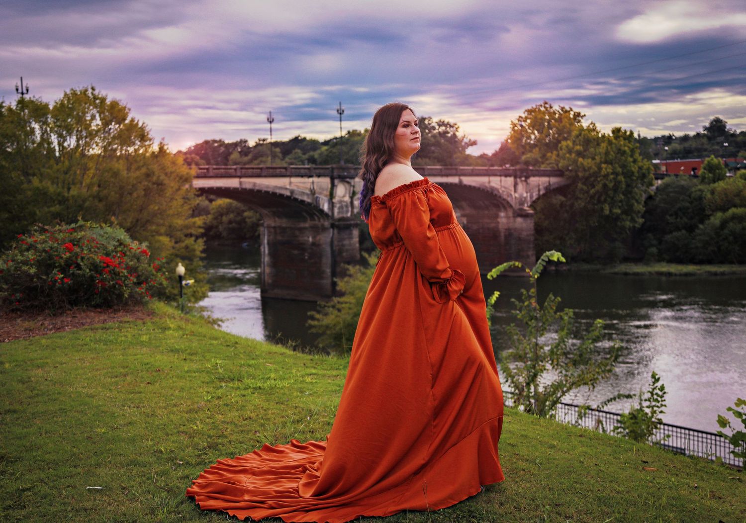 Dressed in Flutter Dress overlooking the Riverwalk in Columbus Georgia for maternity glamour