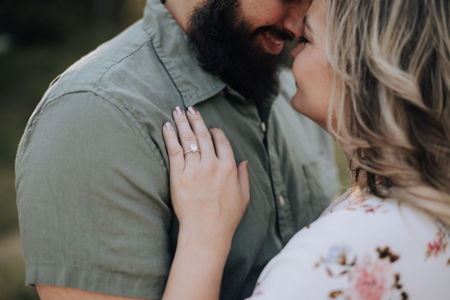 Intimate close-up of couple sharing a tender moment outdoors.