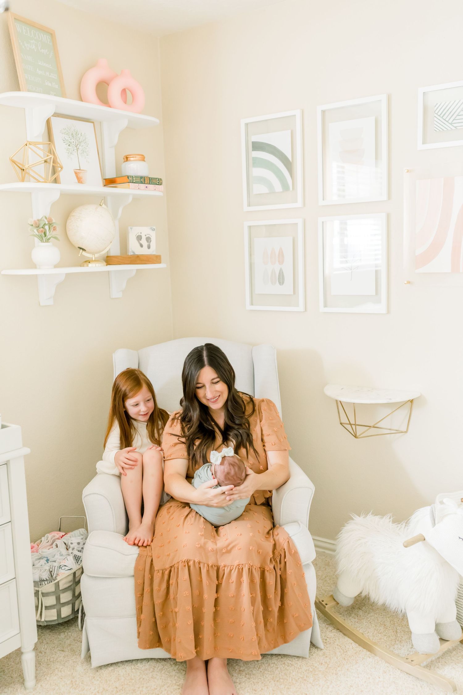Modern nursery setting with minimal decor, floating shelves, and pastel artwork.