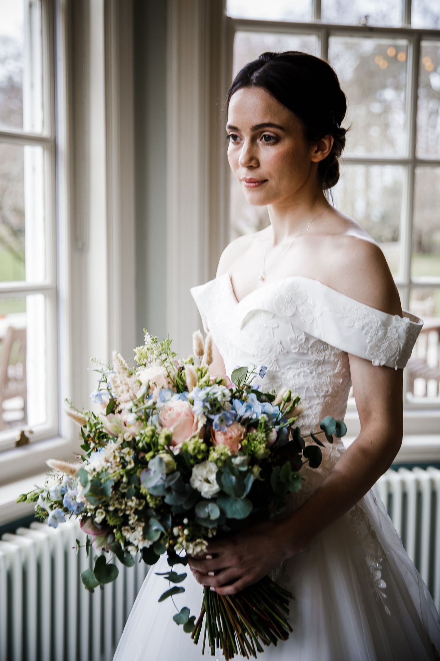 Bride in her wedding dress and flowers ready in dressing room at Kelham House