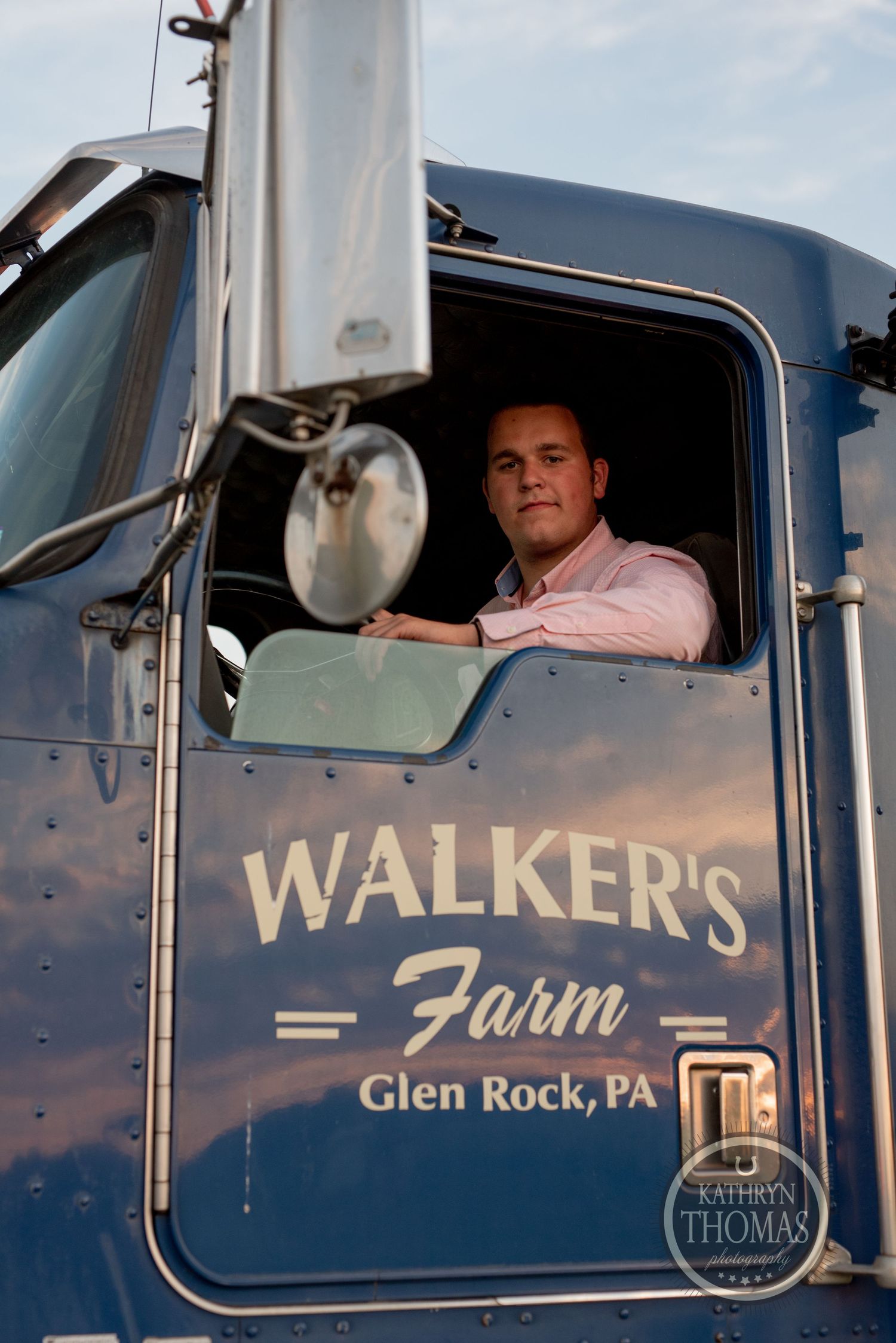Driver sits in cab of Walker's Farm truck from Glen Rock, PA.
