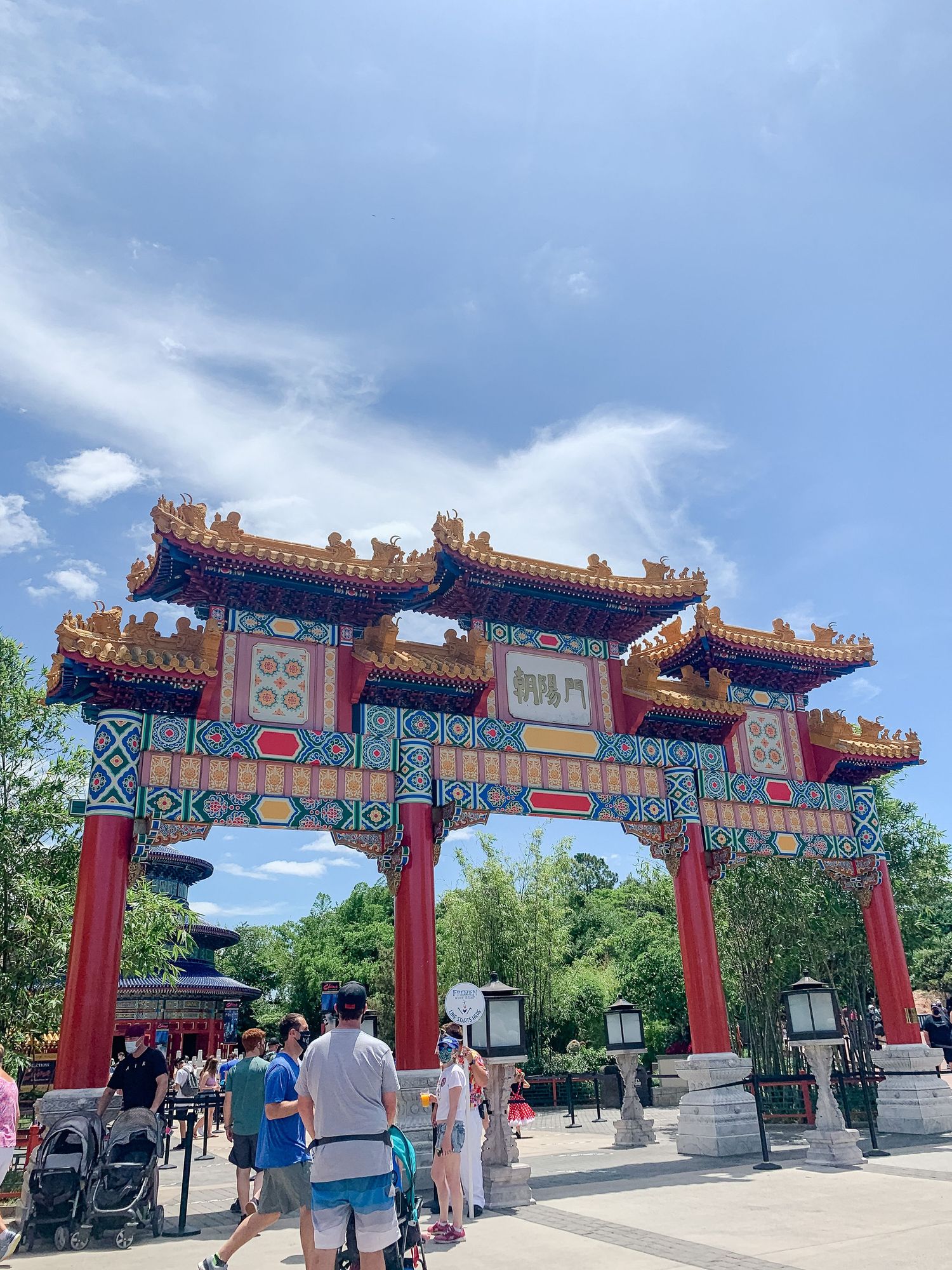 Traditional Chinese ceremonial gate with ornate decorations and bright colors at EPCOT's China pavilion.
