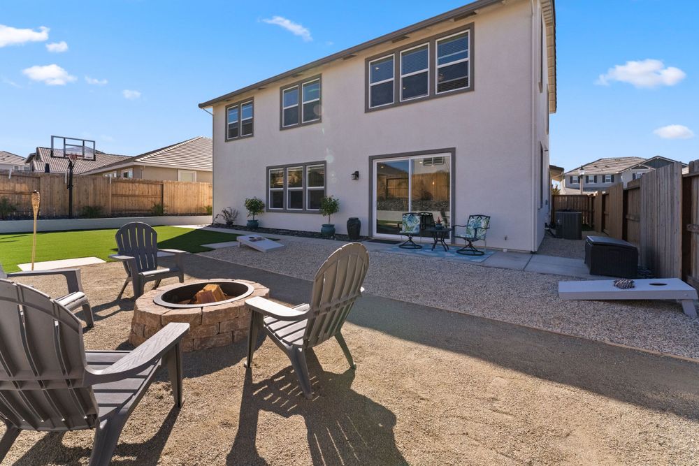 Backyard space featuring outdoor seating area with fire pit and desert landscaping.