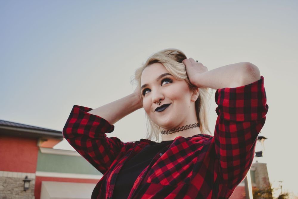 A young woman smiling and looking to the sky on a warm fall evening