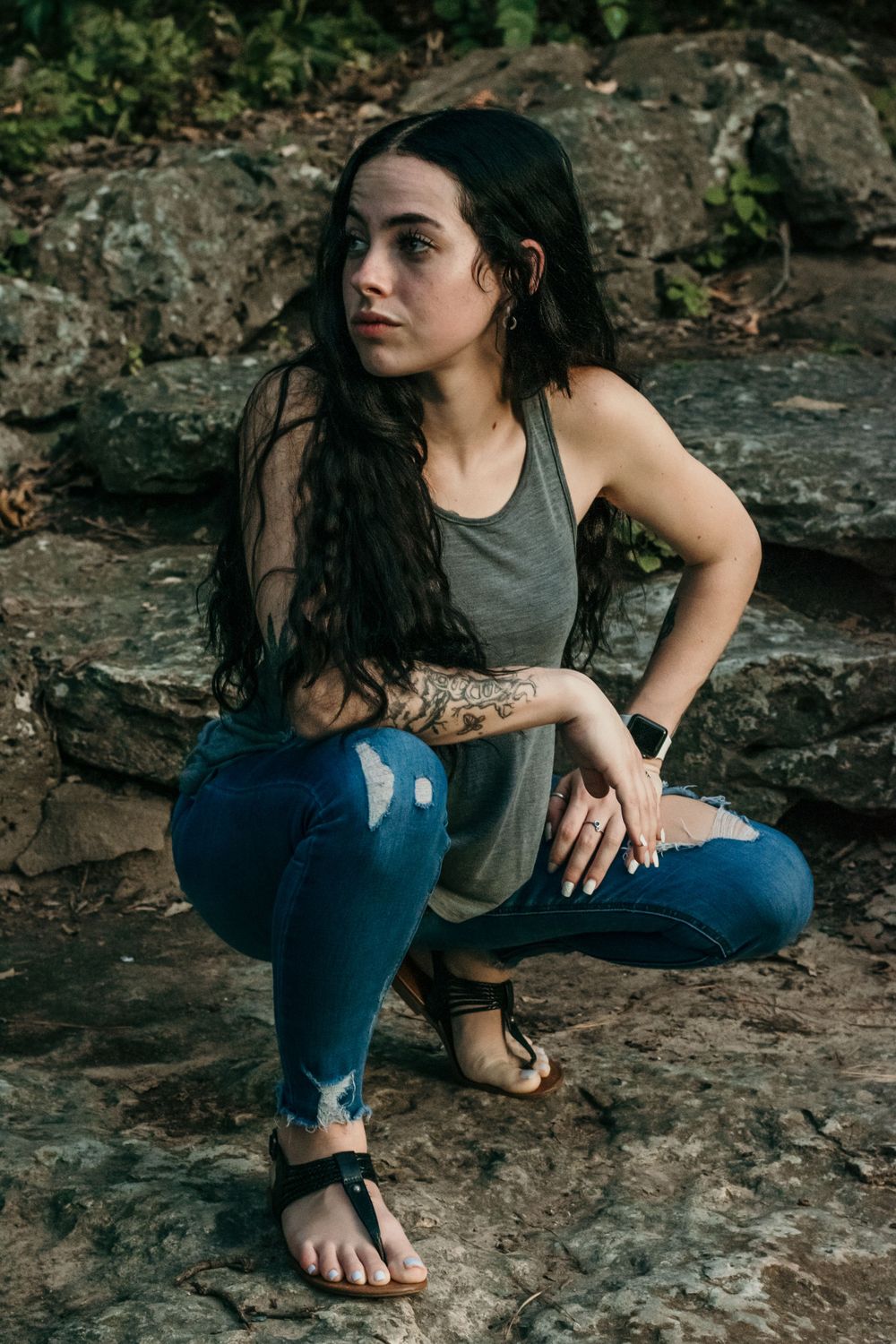 A young woman glances to the side, showing her stunning features and cute outfit