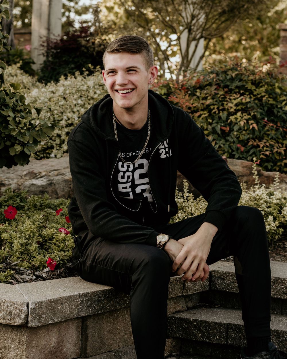 A young man laughing as he poses for senior photos