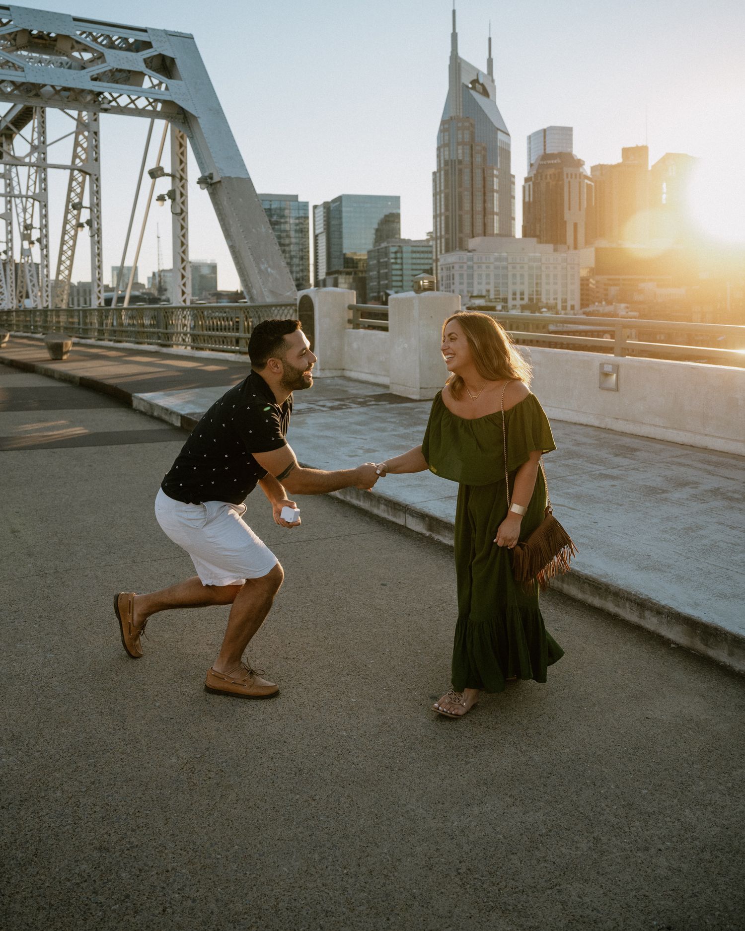 A romantic proposal sequence unfolds against a cityscape backdrop at sunset.