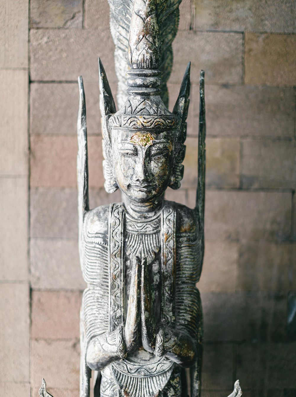 A serene Buddha statue seated on a majestic throne at Paresa Resort in Phuket, Thailand.