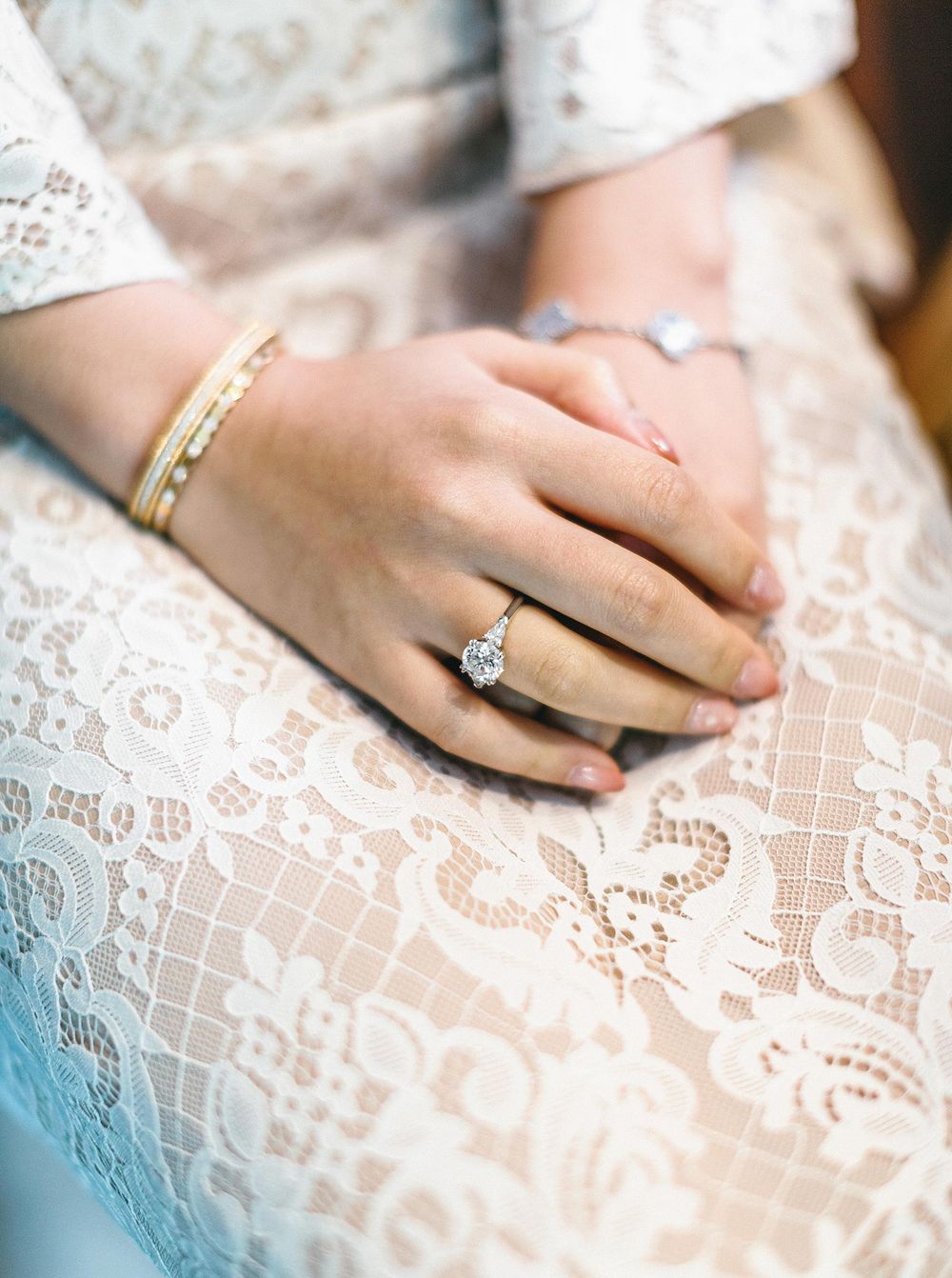 Bride in luxury wedding attire holding hand, preparing in Phuket, Thailand.
