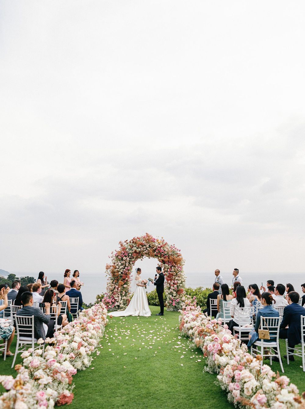 A professional fine art wedding photographer capturing moments at a wedding ceremony in Paresa resort, Phuket, Thailand.