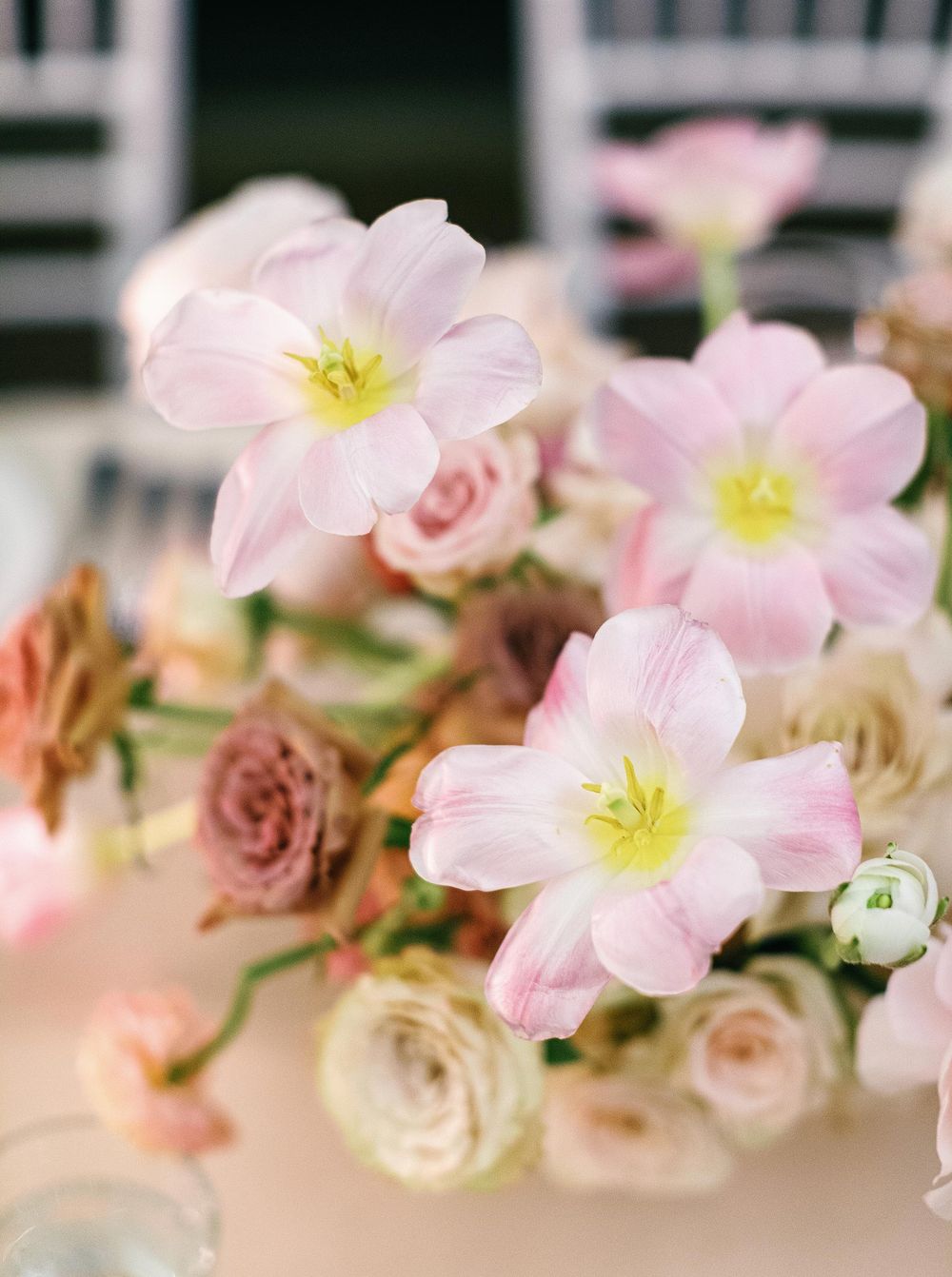 Floral table arrangement with pink and white flowers at a wedding reception in Phuket, Thailand.