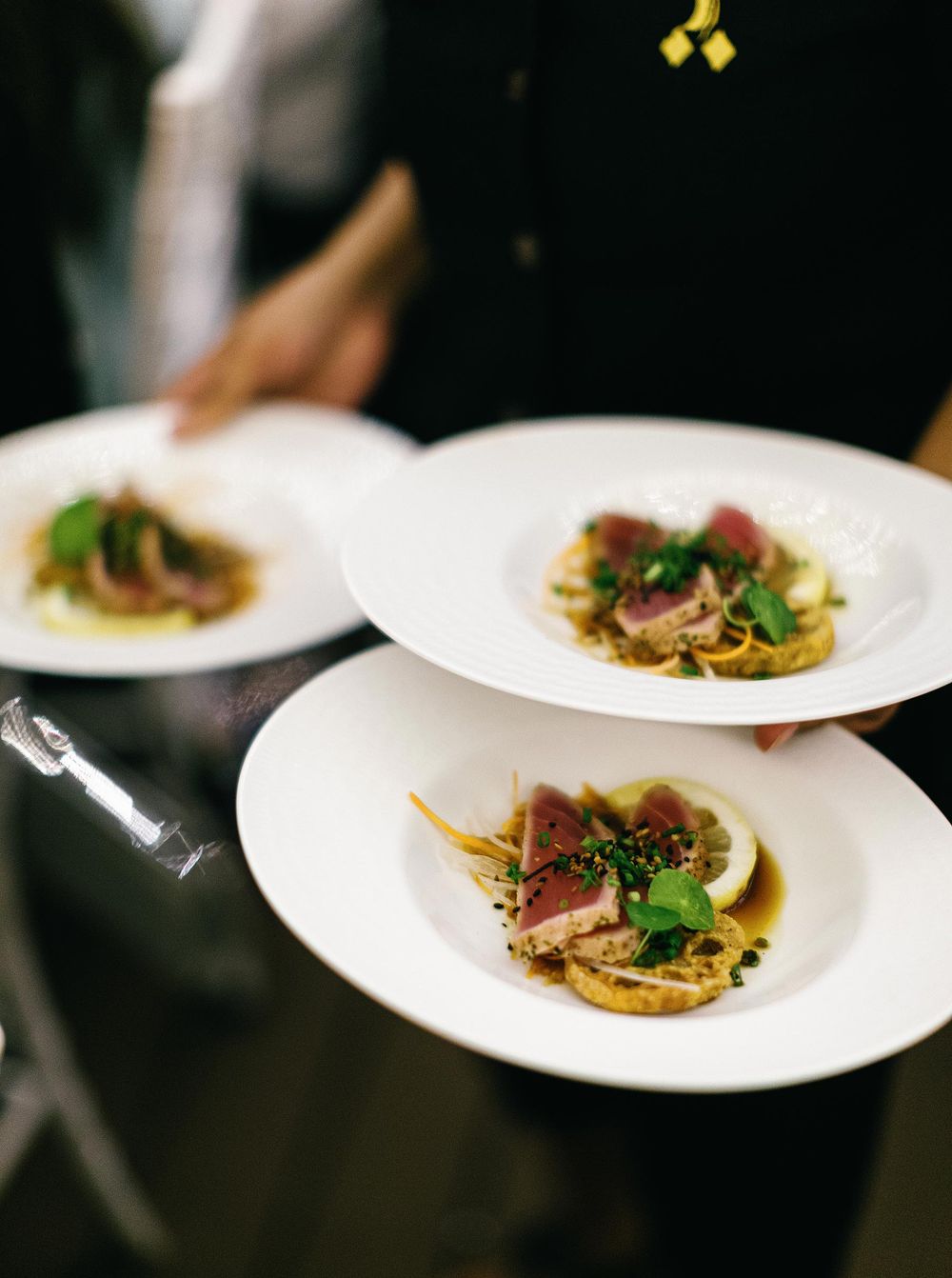 A person holding a plate of food at a wedding reception in Phuket, Thailand.