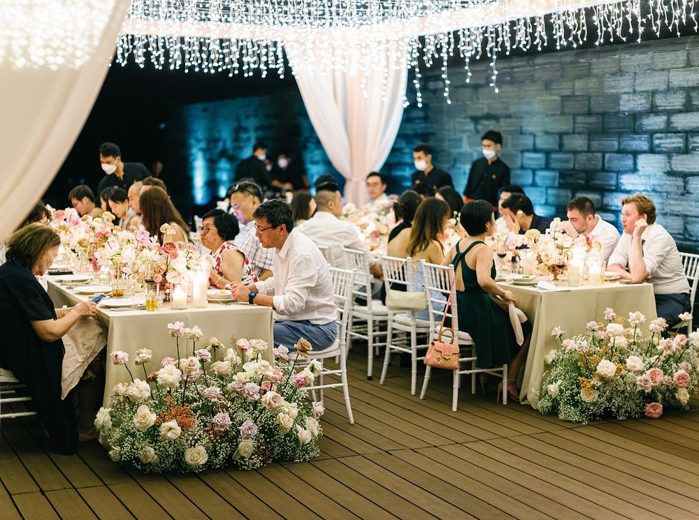 Phuket wedding reception: Tables filled with guests enjoying the festivities of the joyous occasion.