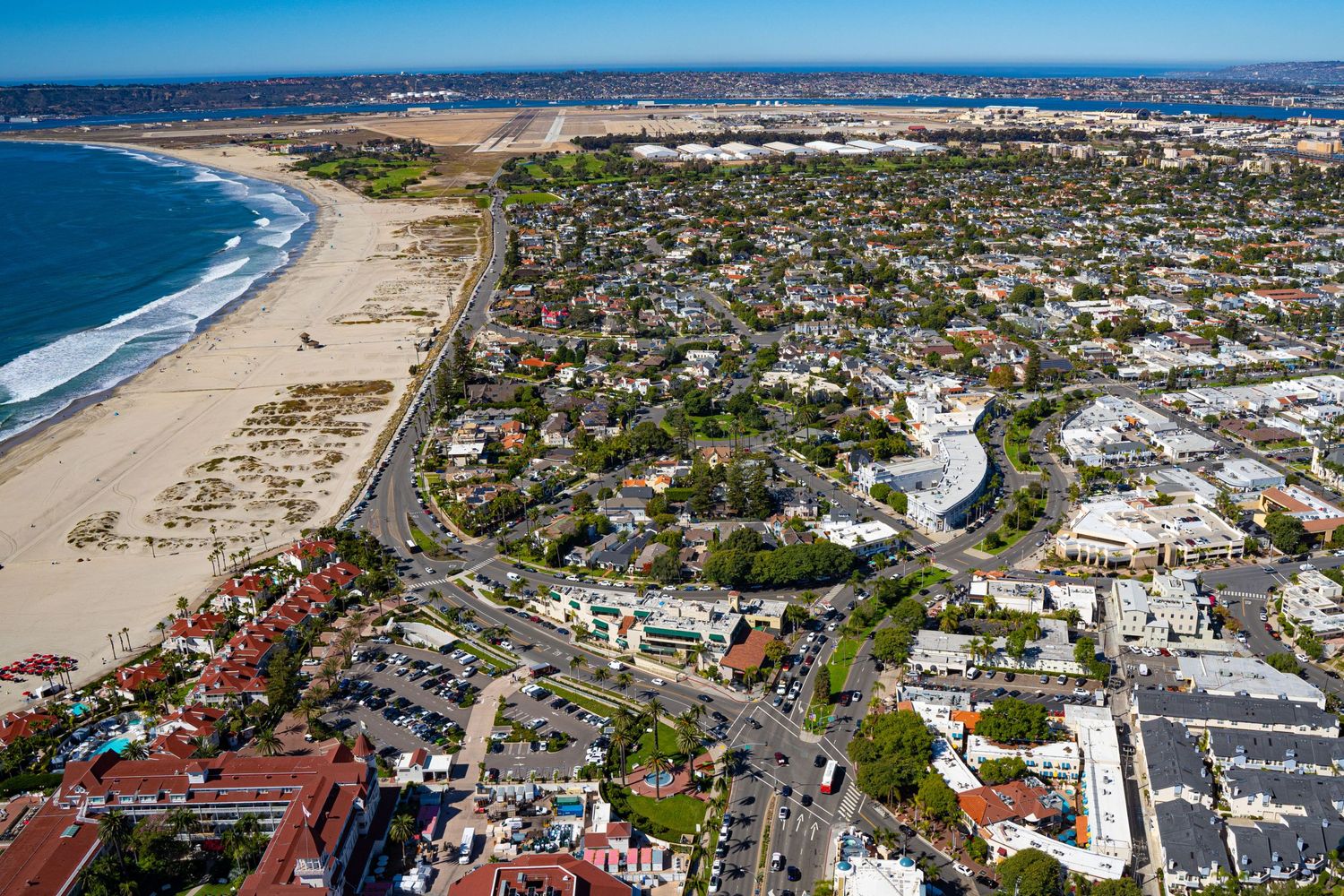 Overhead view of coastal properties, residential streets, and beachfront development in Coronado, California.