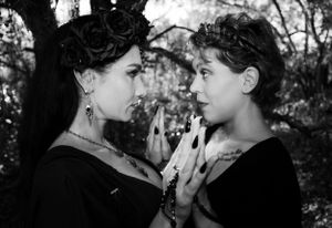 Black and white portrait of gothic models in an intimate dramatic scene.