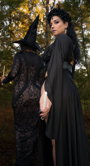 Elegant black lace and flowing capes captured in atmospheric woodland photography.