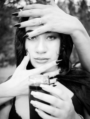 Artistic black and white portraits with dramatic hand gestures and dark aesthetics.